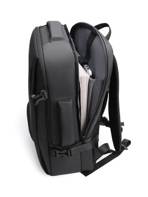 Black convertible commuter backpack with open main compartment showing books and laptop.
