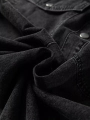 Black denim button-up dress with raw hem detail and button closure.