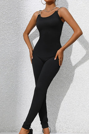 Black jumpsuit with chain straps and a sculpted bodice.