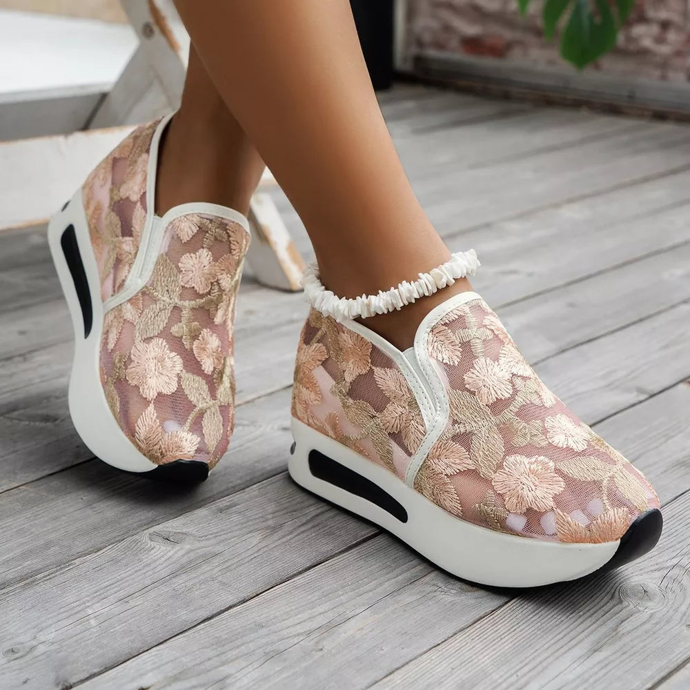 Pink floral embroidered mesh slip-on sneakers with white platform soles and black accents.