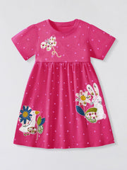 Pink polka dot cotton dress with embroidered animals and flowers, crew neck, short sleeves.