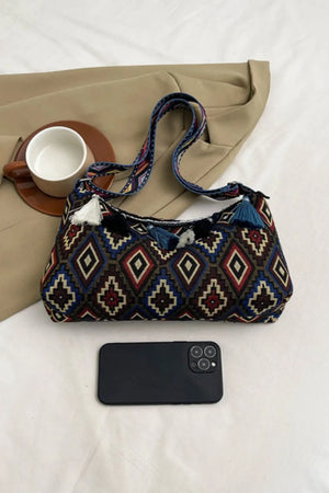 Geometric embroidered shoulder bag with tassels and patterned strap