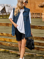 Sleeveless denim utility vest in dark wash with button front and chest pockets.
