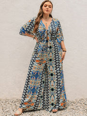 Bohemian palazzo jumpsuit in Peacock Blue with tie-front, bell sleeves, and ornate print.