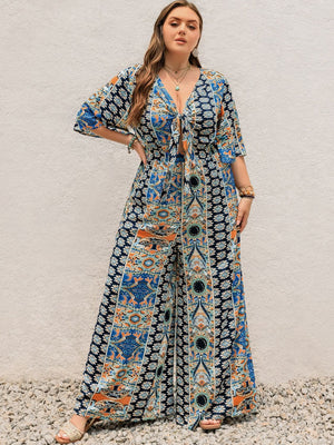Bohemian palazzo jumpsuit in Peacock Blue with tie-front, bell sleeves, and ornate print.