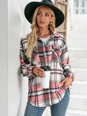 Oversized flannel shacket in blush pink plaid with buttoned patch pockets and a relaxed fit.