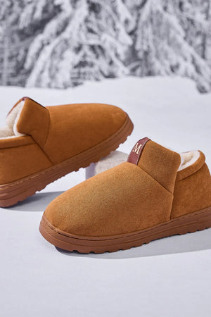 Caramel suede shearling-lined house booties with an M logo tab.