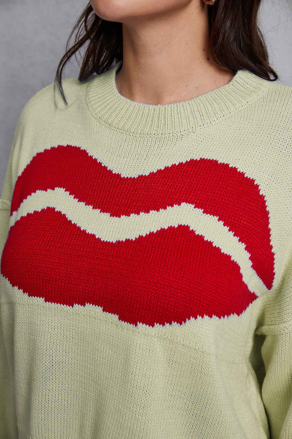 Light Yellow knit sweater with a large red kiss graphic and distressed hem.