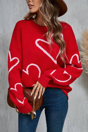 Red acrylic knit jumper with white heart pattern, crew neck, long sleeves.