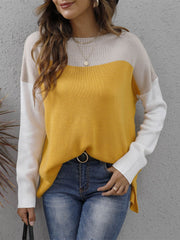 Colorblock crewneck knit sweater in yellow, beige, and white with side slits.