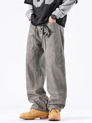 Men's vintage wash wide-leg jeans in grey cotton, featuring a drawstring waist and relaxed fit.
