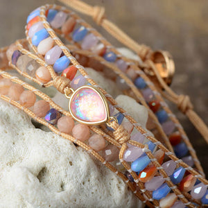 Multicolor gemstone and bead wrap bracelet with a pear-shaped opal charm.