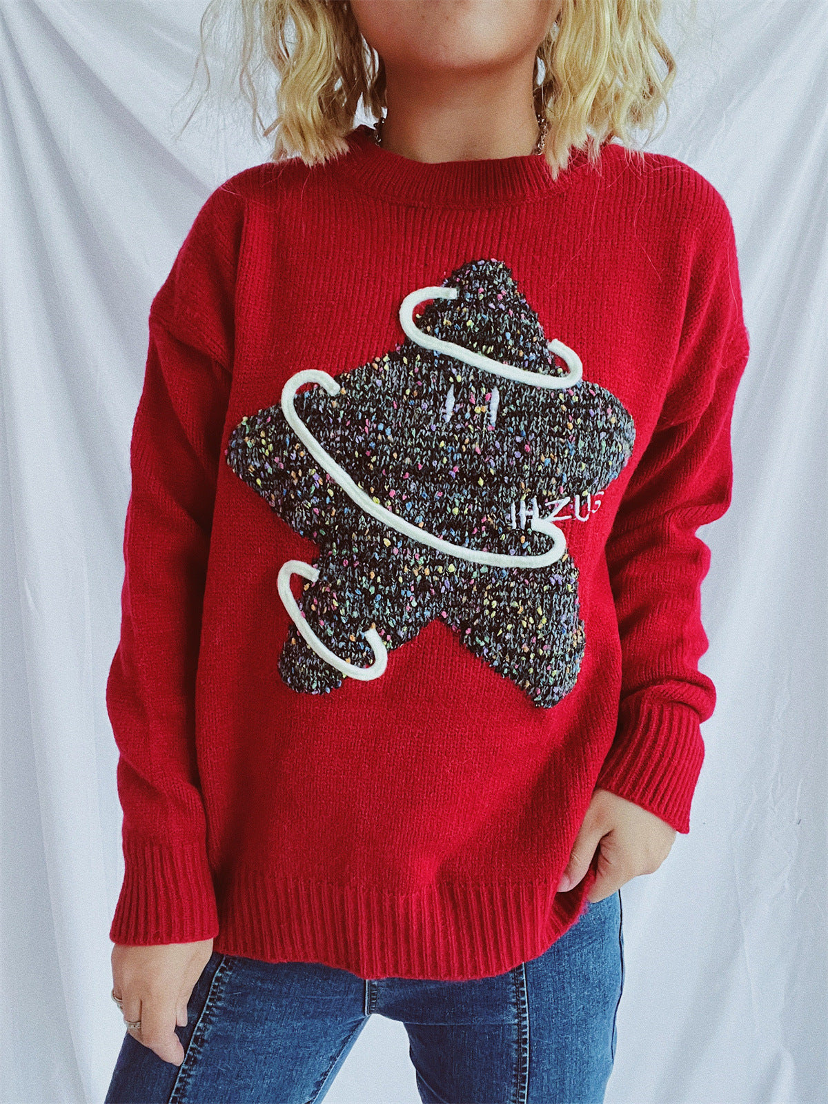 Scarlet knit jumper with embroidered starburst detail and white piping