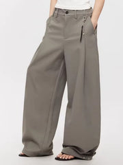 Men's grey high-waisted wide leg sweatpants with button closure and decorative charm.