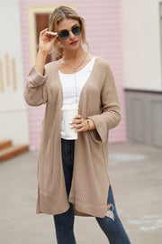 Textured open-front maxi knit cardigan in a light brown acrylic with a relaxed fit and side slits.