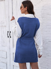 Royal blue knit vest dress with tie and slit, styled over a white shirt.