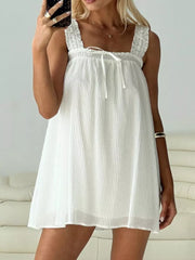White frilled square neck mini dress with drawstring tie and vertical pleats.
