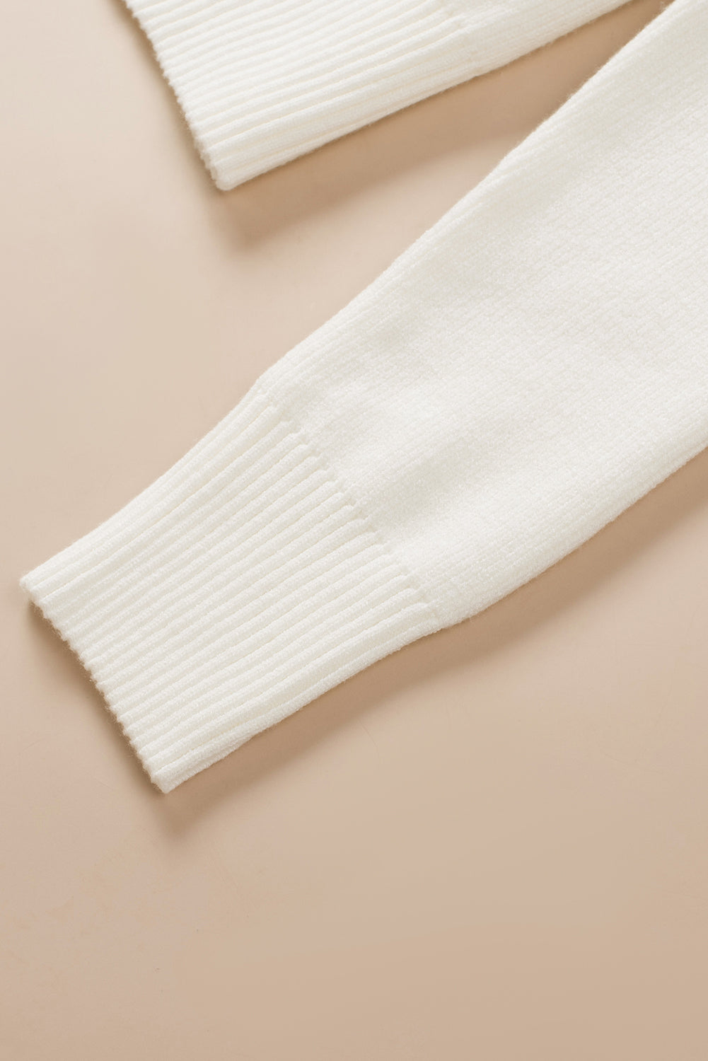 Ivory ribbed knit sweater sleeve detail with ribbed cuff