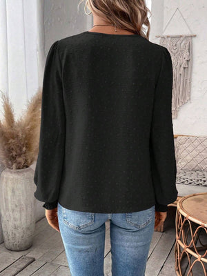 Black embroidered yoke blouse with puff sleeves and textured fabric