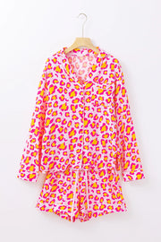 Pink leopard print satin pajama set with collared button-up top and drawstring shorts.