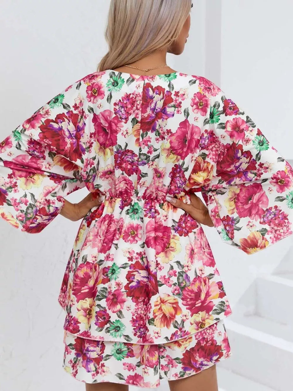 Floral ruffle hem mini dress with wide sleeves and a cinched waist.