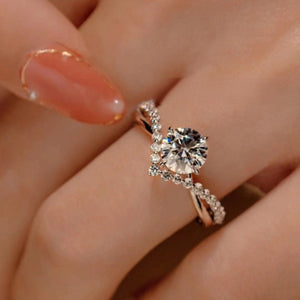 Sterling silver ring with round moissanite and accent stones.
