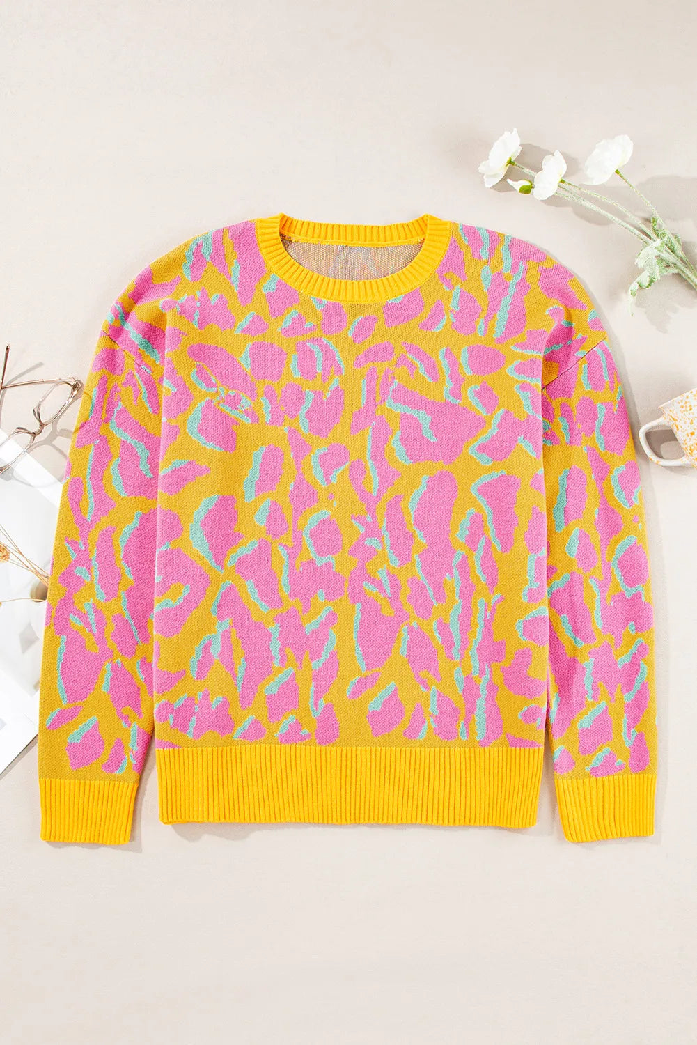 Women's crew neck sweater in yellow with abstract pink and blue leopard print.