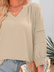 Khaki polyester blouse with V-neck, smocked cuffs, and eyelet sleeve detail.