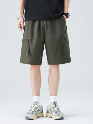 Men's military green cargo shorts with zippered pockets and drawstring waist.