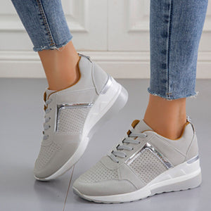 Grey lace-up wedge sneakers with metallic accents and perforated details.