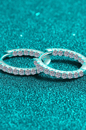 Silver pavé crystal huggie hoop earrings with sparkling stones.