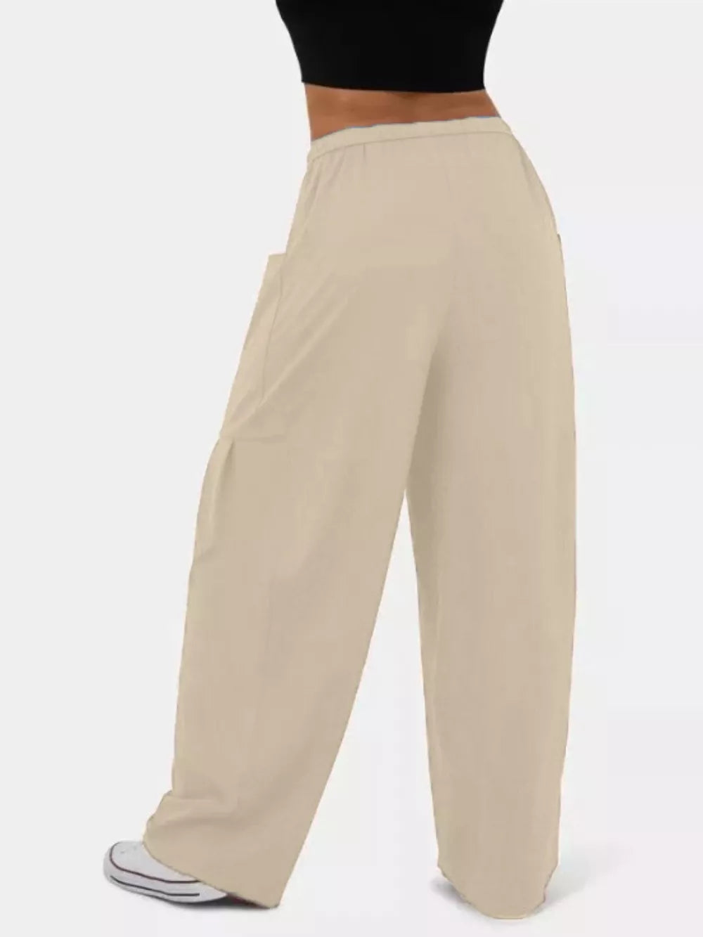 Tan jeggings with wide legs and drawstring waist, featuring cargo pockets.