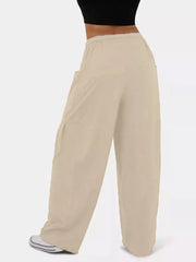 Tan jeggings with wide legs and drawstring waist, featuring cargo pockets.