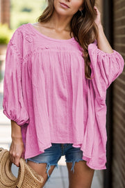 Pink embroidered yoke gathered sleeve blouse with textured fabric and scoop neck.