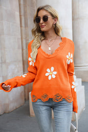 Orange sweater with daisy appliques and distressed edges, V-neck, long sleeves.