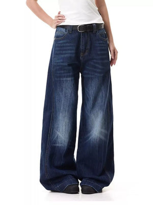 Belted wide leg jeans in washed denim with a relaxed fit and subtle vertical stripes.