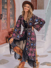 Bohemian floral duster with fringe, bell sleeves, and multicolor pattern.