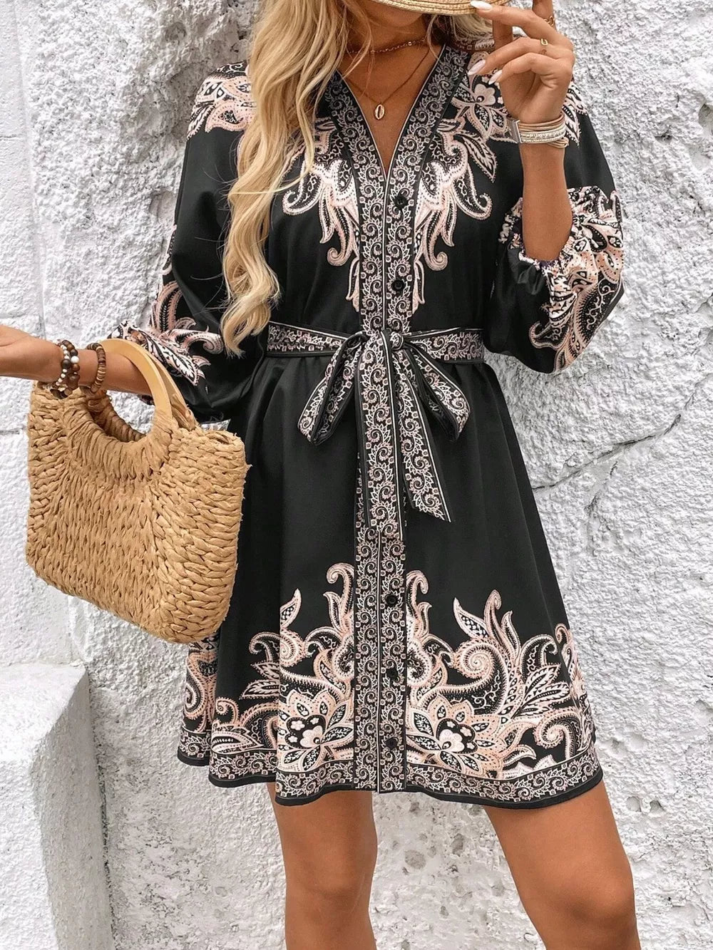Black paisley print mini dress with V-neck, billowy sleeves, and waist tie