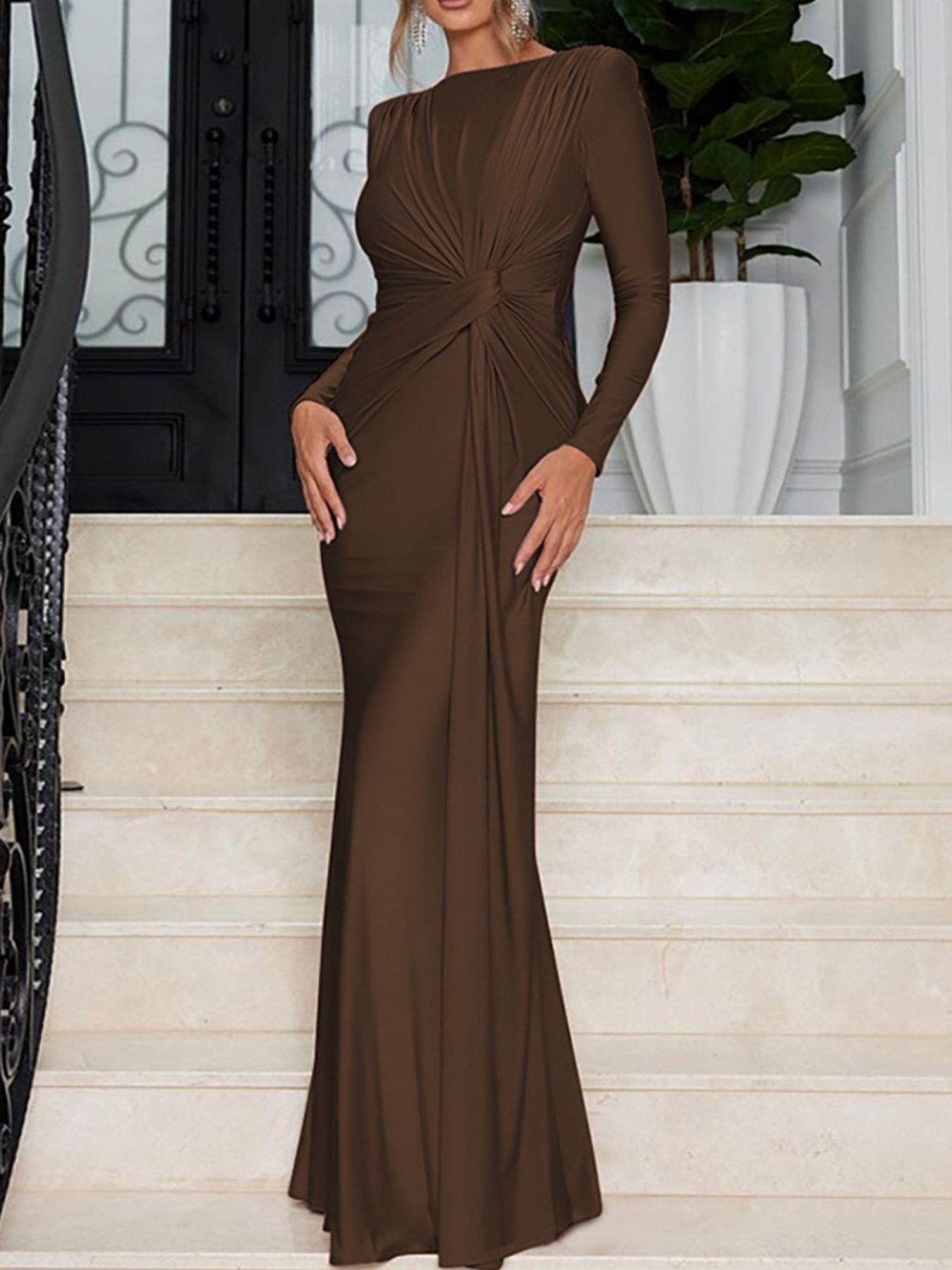 Brown ruched knot front maxi dress with long sleeves and a fitted silhouette.
