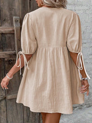 Beige tie front puff sleeve mini dress with adjustable tie cuffs