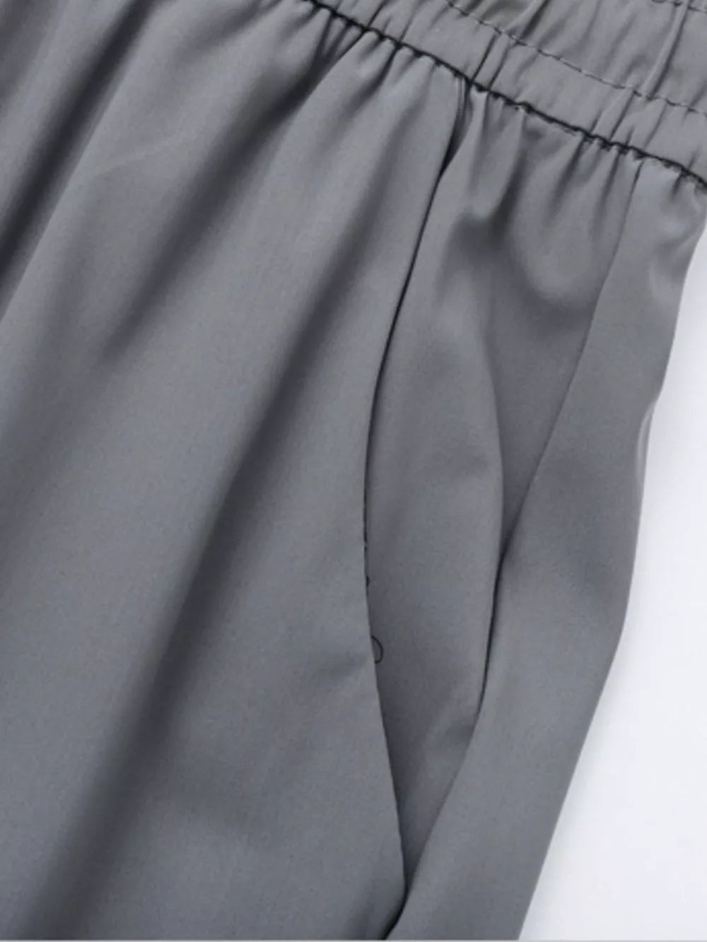 Grey sweatpants with elastic waistband and side pocket detail