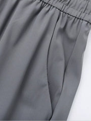 Grey sweatpants with elastic waistband and side pocket detail