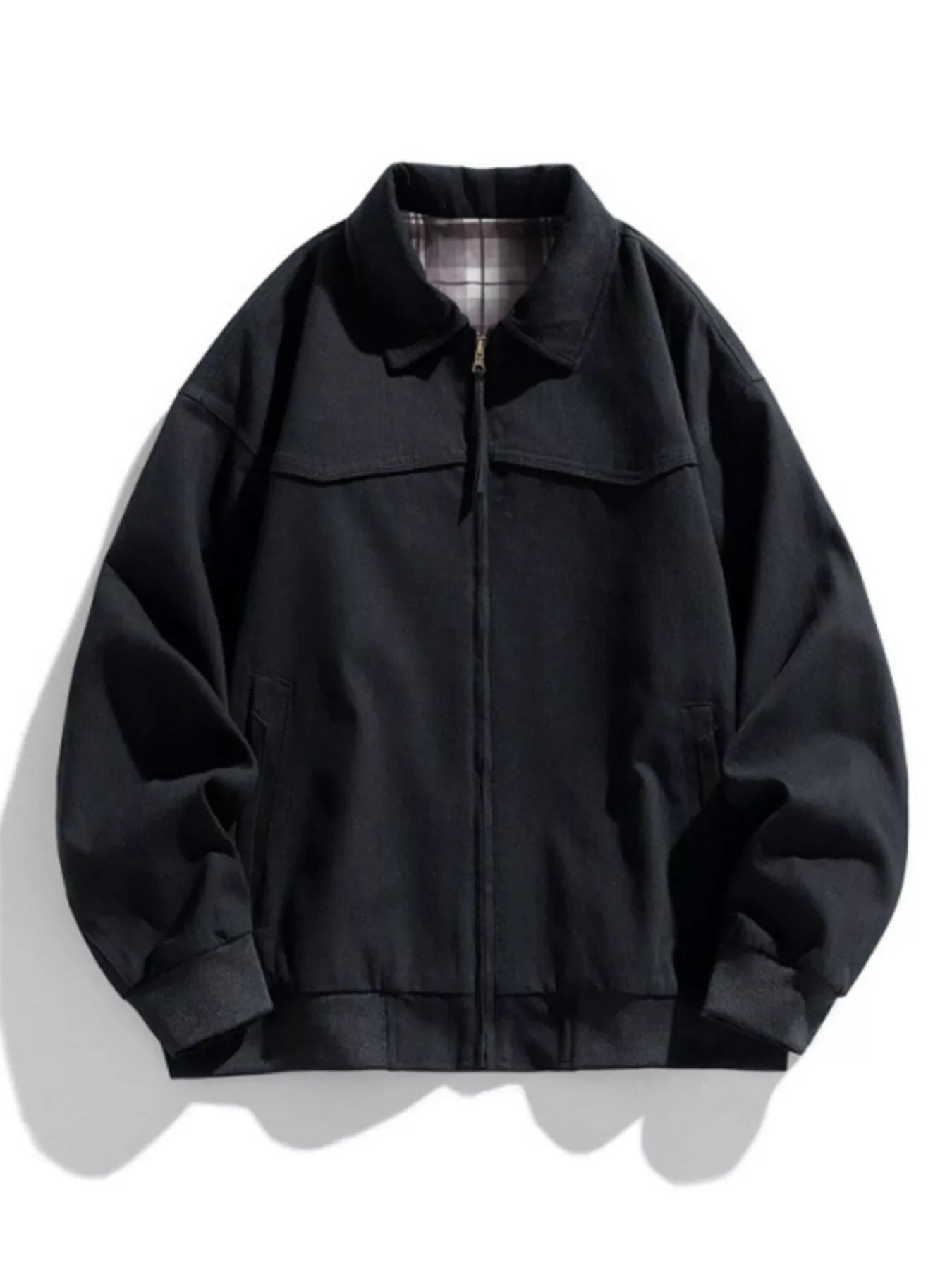 Black oversized zip-up jacket with plaid lining and elastic cuffs.