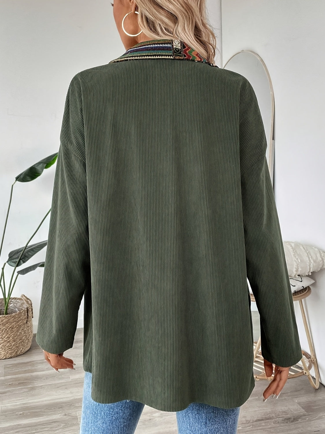 Army green corduroy overshirt with embroidered collar detail and relaxed fit.