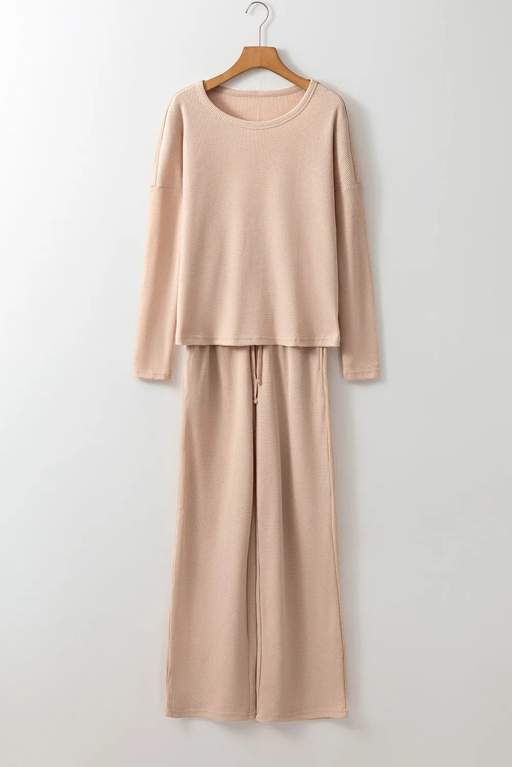 Tan textured ribbed lounge set with long sleeve top and wide leg pants with drawstring waist.