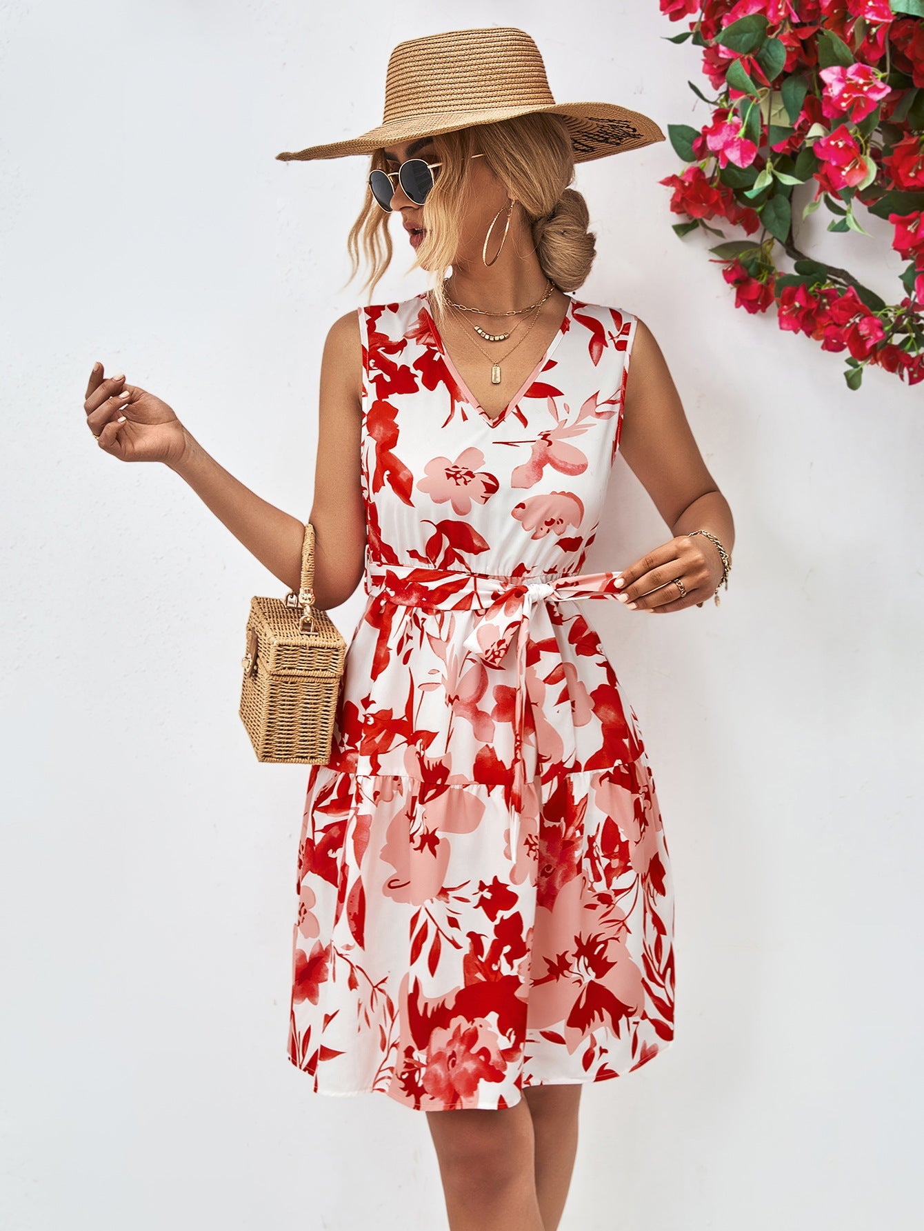 Watercolor floral tiered mini dress in red and pink on white, with V-neck and tie waist.