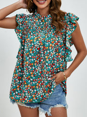 Smocked yoke ruffle sleeve floral blouse in dark blue with a mock neck.