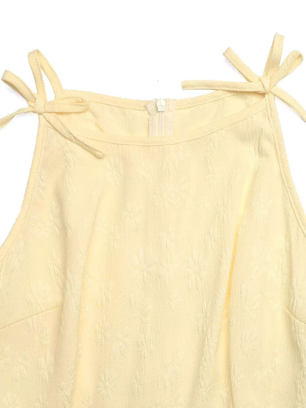 Yellow textured wide-leg jumpsuit with tie straps and a zipper closure.