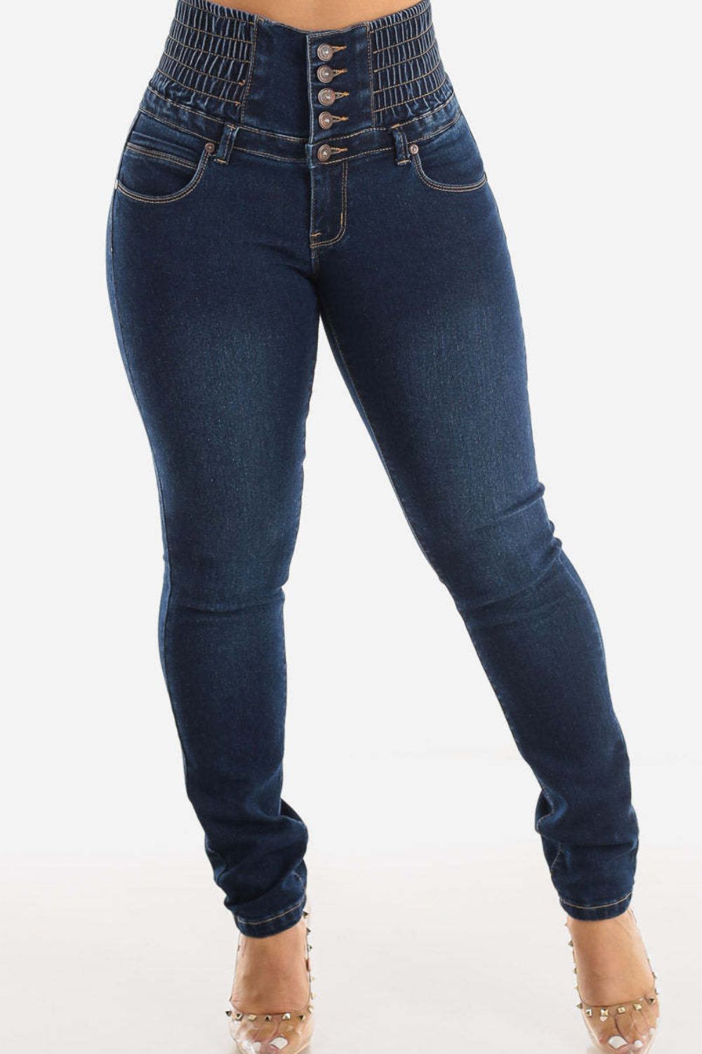 Dark wash skinny jeans with a high-rise, button-fly, and elasticated sculpted waistband.