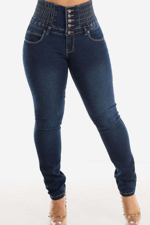 Dark wash skinny jeans with a high-rise, button-fly, and elasticated sculpted waistband.